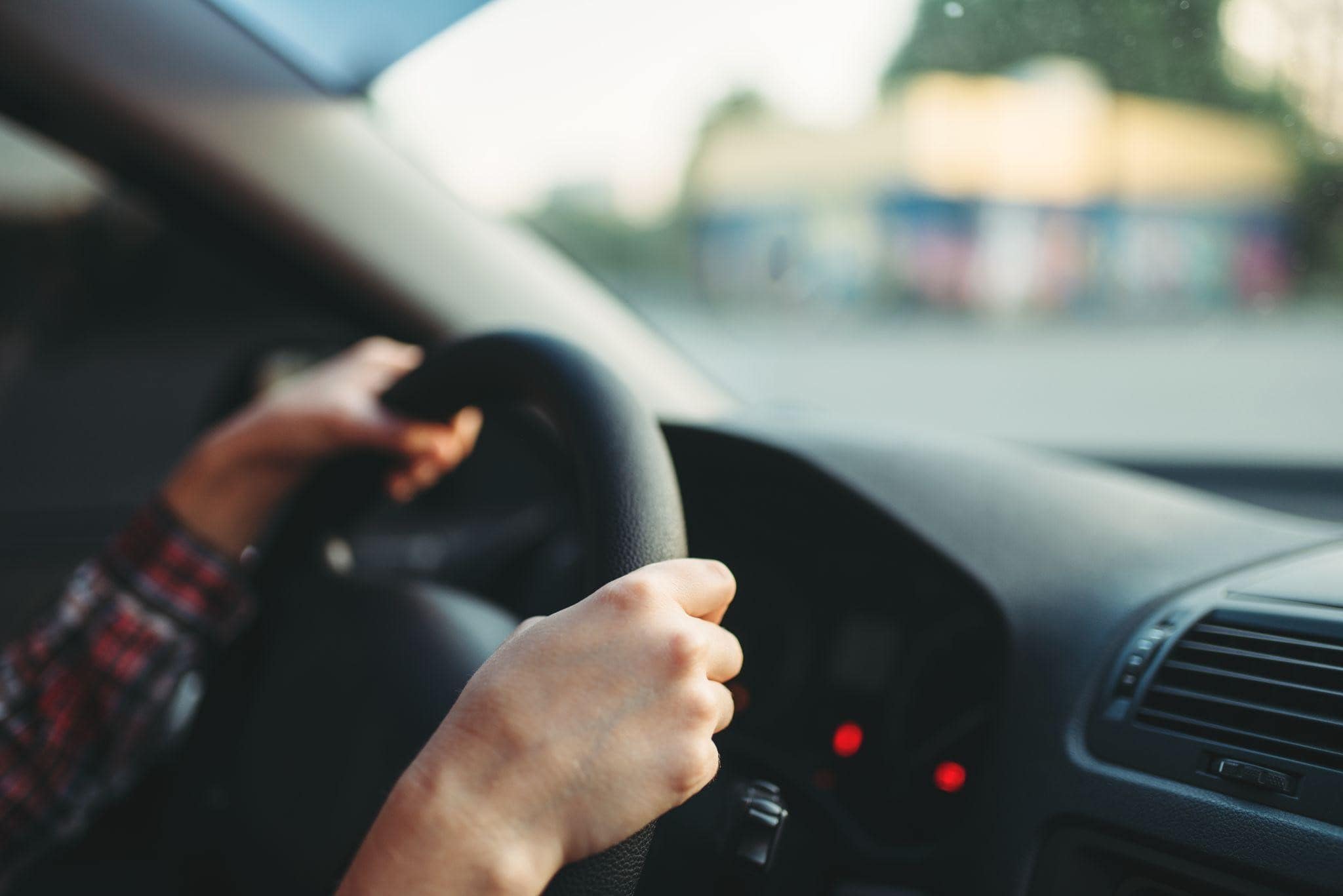 A student driver clinging to the wheel